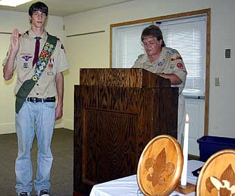 EARNING THE EAGLE -- On Sunday, Oct. 7, a Boy Scout Court of Honor ceremony was held at the Stewartville Sportsman's Club to honor Andrew Skuster, left,  who has earned the Eagle Award, Scouting's highest honor. Scout leader Barb Hill, right, pays tribute to Skuster during the ceremony. 