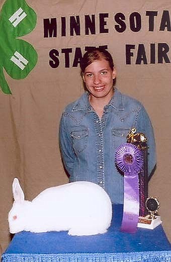 Carolyn Zylstra, pictured with her Grand Champion ribbon at the Mnnesota State Fair. Carolyn's ribbon was awarded for her New Zealand rabbit.  She is a member of the Interstate Hi-Flyers 4-H Club. 