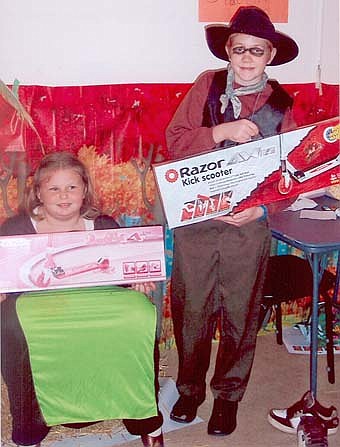 Stewartville Assembly of God had a very successful Harvest Festival Oct. 31 with lots of games, food and prizes. Keyannah Buck, left, and Peter Cain, right, are pictured where their prizes following the kids drawing. Adult drawing winners were Jamie Hubert and Crystal Vale, each winning an Angel Food Ministries "Bread of Life" Signature Box of food, which provides balanced nutrition and variety with enough food to help feed a family of four for about a week at a cost of only $31. Angel Food Ministries is a program available to anyone wanting to stretch their food dollars. 