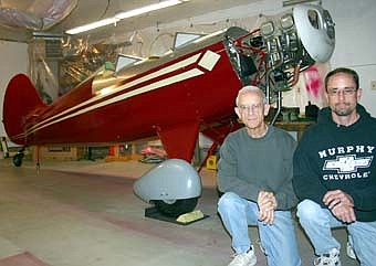 ALMOST READY TO FLY -- John Hanson, left, and his son Jeff have worked together for more than eight years in John's garage to build a Hatz Classic Biplane. Working from basic drawings, they assembled the plane using steel tubing, steel sheet metal and wood. "Part of it was studying it and looking at it and scratching our heads," John said. "We looked at other airplanes and got ideas, and we used information from the Internet." The Hansons hope the two-seater plane will be ready to fly by next summer. 
