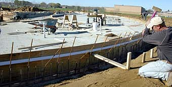 NEW POOL TAKES SHAPE --Stewartville's new swimming pool, scheduled to be completed next June, is beginning to take shape. Brian Teff of Pool Constructors of Eagan, works near the zero-depth area.  Teff said that the pool's shell should be finished by the end of this week. 