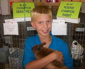 Taylor Morgan of the Racine Ramblers 4-H Club did well during the Mower County Fair. Pictured is Taylor, with his Champion Mini Rex. Taylor also received Reserve Champion Rabbit Overall.  