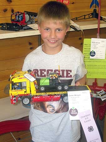 Carter Morgan, a Member of the Racine Ramblers 4-H Club did well during the Mower County Fair.  Pictured is Carter Morgan with his Champion Robotics project.  