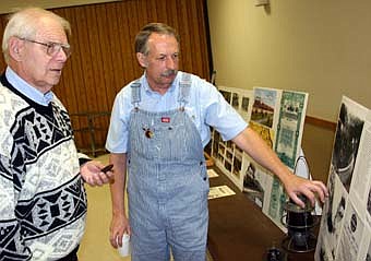 A HISTORY LESSON -- Roger Byrne of Racine, at right, points to some information on a display he brought to the Stewartville Area Historical Society's annual meeting at the Stewartville Civic Center on Sunday, Oct. 28. Darrel Splittstoesser, left, who attended the event, looks on.  