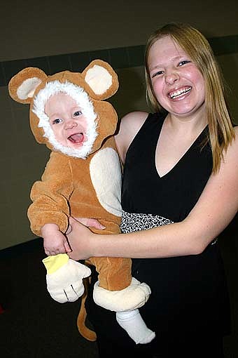 MONKEYING AROUND -- Justice Casey, 8 months, is dressed as a monkey at the Halloween event at Stewartville High School last Wednesday, Oct. 31. Valerie Mangskau of Rochester holds her son. 