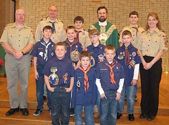 Boy Scouts and their leaders from Troop 56 and Pack 156 celebrated Scout Sunday at St. Bernard's Parish on Feb. 5. Front row from left, Edward Becker, Alan Bredesen, and Thomas Root. Middle row, Roger Mueller, Nicholas Otto, Patrick Miller, William Mueller, Nathan Edholm, and Amy Edholm. Back row, Rob Miller, Josh Beecher, Father Matt Fasnacht, and Kevin Christian. 
