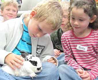 Blake Turner, a student in Kallie Fitzloff's kindergarten class at Bonner Elementary School, gently touches a rabbit that visited the school for a special Kindergarten Ag Day last Wednesday, April 18. Other kindergartners waiting for their opportunity to touch the bunny include Andrew Mayer, far left, and Bella Vasoli. For more details about Kindergarten Ag Day, see Page 16.  
