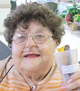 Mavis Webster, a resident of the Stewartville Care Center, holds a small May basket filled with candy she received from the Stewartville Lioness Club on Tuesday, May 1. Goodies included M&Ms, malted milk balls, a peanut butter cup and more. 