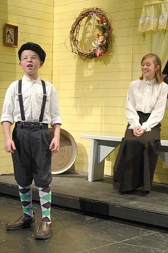 Derrick Fritz, a Central Intermediate School fifth-grader, cast as Winthrop Paroo, sings "Gary, Indiana" as Sara Zent (Marian Paroo) looks on.  