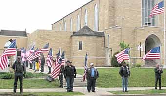Members of the Minnesota Patriot Guard stand outside St. Francis of Assisi Catholic Church in Rochester during the funeral for Nick Dickhut, a 2007 graduate of Stewartville High School, last Tuesday, May 8. Dickhut was killed in combat in Afghanistan on Sunday, April 29.  