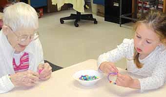 The children from the Preschool II room at Endless Journey Child Care attended a fieldtrip to the Stewartville Care Center on Wednesday, April 25. The children and residents made beautiful jewelry together and then enjoyed a snack of yummy cookies.  Here, Care Center resident Lucille Voeltz and Madison Sogla of Endless Journey Child Care concentrate on their jewelry creations. 