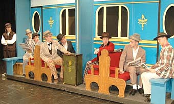 YOU GOTTA KNOW THE TERRITORY -- Passengers  aboard a train headed for River City, Iowa, sing enthusiastically in the opening scene from "The Music Man," the Stewartville School District production to be presented at the SHS Performing Arts Center this Thursday, Friday and Saturday, Nov. 15, 16 and 17 at 7:30 p.m.  each evening. Cast in lead roles are Sara Zent as Marian Paroo and Noah Nelsen-Gross as Professor Harold Hill.  Ken Mann, the director of the show, said that 54 students in grades four through 12 will be part of the production. 