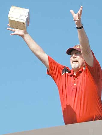 Dave Nystuen, Bonner principal, drops a packaged egg from the school's roof.  