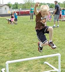 Riley Schild gives it his all as he clears a hurdle at the Bonner track meet.  
