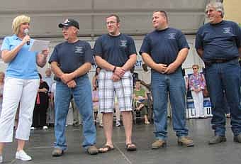 The Podein family was honored on the main stage at Rochesterfest last week as a recipient of the annual "10 Who Make a Difference" Award, given to Rochester and area individuals, organizations or families that serve their communities in extraordinary ways. The Podeins were honored for their service as long-time volunteers with the Stewartville Fire Department. Robin Wolfram, news anchor at KTTC-TV&#8200;in Rochester, left, introduced the Podeins to a large audience. The Podeins include, from left, Mike, Josh, Ryan and Mark. 