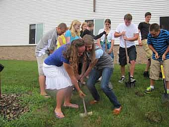 Young members of Grace Evangelical Free Church help break ground for a new 3,400 square-foot addition to the church on Sunday morning, July 29. The teens include, in front, from left, Katie Scruggs and Emily Tompkins, and in back, from left, Alex Campbell, Hannah Blomquist, Sarah Blomquist, Zach Scruggs, Will Gisler and Isaiah Scruggs. Gary Kadansky, a deacon at the church, said that the new addition will give Grace Church more flexibility to address programs for youth, including middle school and high school ministries and the church's AWANA program.   