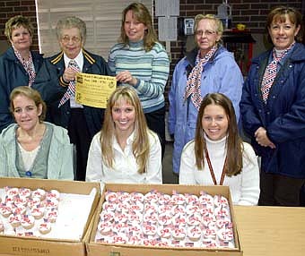 THANKS TO THE EDUCATORS -- Members of the Stewartville American Legion Auxiliary celebrated American Education Week last week by delivering cupcakes to local schools, including Bonner Elementary School,  Central Intermediate School,  Stewartville High School and Stewartville Middle School. At Bonner, the visitors were welcomed by a number of educators, including, seated, from left, LaRae Bushman, a paraprofessional; Kellie Krueger, a third-grade teacher; and Christin Hale, a Title I paraprofessional. Standing, from left, are Legion Auxiliary members Cheryl Roeder and Viny Byrne, along with Maryan Gisler, Bonner secretary, and Carole Kiehne and Judy Schroeder of the Stewartville American Legion Auxiliary. 