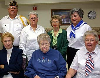 HONORING OUR VETERANS -- Members of the Stewartville American Legion Auxiliary Unit 164 served cake and ice cream to local and area veterans at a Veterans Day ceremony at the Stewartville Care Center on Monday, Nov. 12. Legion Auxiliary members include, front row, from left,  Fran Janssen, Dorothy Marshall and Charlotte Kath. Back row, from left, Richard Paulson, commander of Stewartville American Legion Post 164,  along with Auxiliary members Karen Freiheit, Margaret Andreason and Barb Viker. 