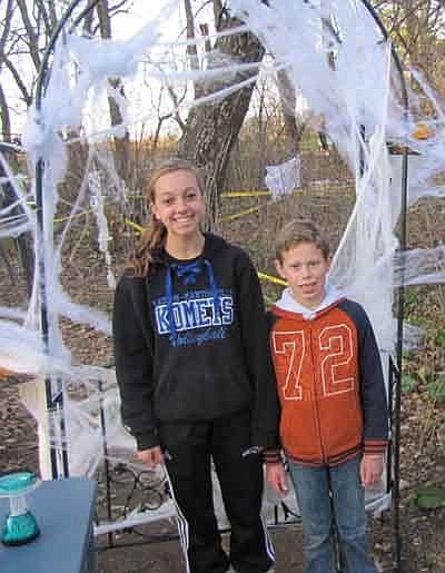 Gabe Nelson, a sixth grader at Stewartville Middle School, left, and his cousin Jade Schmeling, an eighth grader at Kasson-Mantorville Middle School, invited hundreds of their friends to "Spook City in the Woods" near Racine on Saturday, Oct. 20. Guests at Gabe's rural home toured "Spook City" after the sun went down that evening, walking through a sectioned-off path in the nearby woods that was decorated with ghosts, witches, spiders and more. The two donated the proceeds from the event to a bullying prevention organization. For more details, see the feature story on Page 8. 