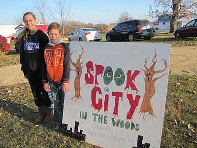 Gabe Nelson, a sixth grader at Stewartville Middle School, and his cousin Jade Schmeling, an eighth grader at Kasson-Mantorville Middle School, stand near the Spook City sign, then make a couple of stops along their scary path. 
