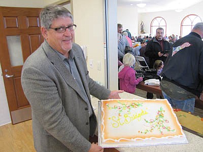Jim Kuisle displays the cake that was served to celebrate the opening of St. Bridget's Catholic Church's new social hall.     