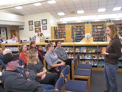 Mindy Mejia of St. Paul, standing at right, discusses The Dragon Keeper, her first novel, with an audience at the Stewartville Public Library on Saturday, Oct. 20.
