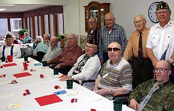 A GATHERING OF VETERANS -- Veterans who live at the Stewartville Care Center, Stewartville Apartments and Root River Estates gathered for a Veterans Day ceremony at the Care Center on Monday, Nov. 12. They are, seated from left, Warren Frie, Ernie Christie, Carl Hoover, Norb Schroeder, Wendell VanderBie, Clayton Paulson and Kevin Chinn. Standing, from left, Harry Geerdes, Bill Holzer, Amos Henke and Richard Paulson, commander of the Stewartville American Legion Post 164. 