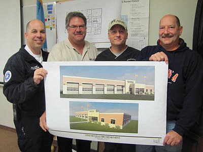 Firefighters who attended a meeting with representatives of Five Bugles Design of Eau Claire, Wis. last week hold architects' drawings of the new Fire Hall, projected to cost an estimated $1.6 million to $1.8 million. Residents will decide the fate of the new Fire Station in a referendum vote some time next year, possibly in the spring. Firefighters include, from left, Vance Swisher, assistant fire chief; Greg House, a member of the firefighters' building commitee; Bob Robertson, also a member of the firefigh<!--1up-20-->ers' building commit<!--1up-20-->ee; and Steve Wolf, fire chief.     