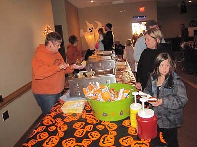 Peggy Paulson of the Stewartville American Legion Auxiliary Unit 164, at left in the above photo, serves sloppy joes, hot dogs, chips and beverages at the Halloween Party at the Legion last Wednesday, Oct. 31.