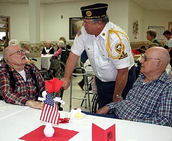 Richard Paulson, commander of the Stewartville American Legion Post 164, center,  spoke with veterans Harry Geerdes, left, and Bill Holzer at a Veterans Day ceremony at the Stewartville Care Center on Monday, Nov. 12.  Geerdes and Holzer live in the Stewartvilla Apartments.  