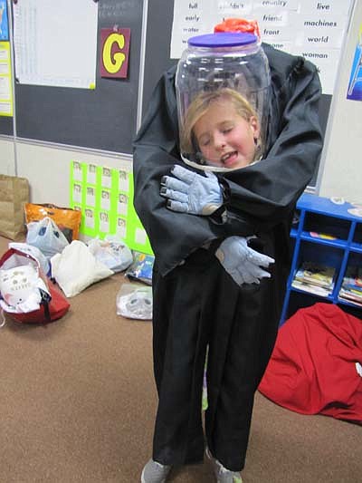 a zombie holds the head of Ellie VanLent, a second grader