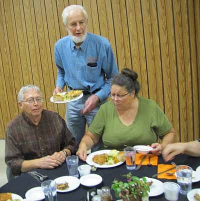 Roy Gisler of the Stewartville Kiwanis Club, standing, serves the guests at a dinner to honor the volunteers at the Center for Active Adults on Monday, Oct. 29. "We thank all of our wonderful volunteers," said Linda Miller, coordinator of the Center for Active Adults.             