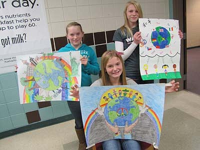 The Stewartville Lions Club sponsors an annual Peace Poster contest for sixth graders at Stewartville Middle School. Student winners at the local level include Ayla Stecher, seated in front, first place; Chrystal Mullenbach, standing at left, second place; and Shae Thomas, standing at right, third place. In all, 137 sixth graders took part in the contest. 