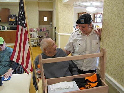 Kristin Anderson, a member of the Legion Auxiliary and the Army National Guard, speaks with Floyd Braaten. 