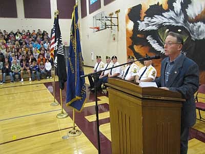 Mayor Jimmie-John King, in foreground, addresses hundreds of students during the annual Veterans Day ceremony at the Stewartville High School gym last Thursday, Nov. 8. "Veterans Day is set aside to remember every man and woman who has taken up arms to defend the United States, " King said. "Twenty-six million military veterans walk among us, and on this day our nation salutes them all."   