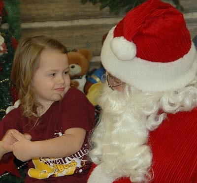Ella Minnich, 4, ponders her Christmas wish list as she talks with Santa Claus at the annual "Pictures With Santa" event at the Stewartville Civic Center on Saturday, Dec. 1. Hundreds of children attended the event, which was sponsored by the Stewartville Kiwanis Club.  Christmas wishes   Ella Minnich, 4, ponders her Christmas wish list as she talks with Santa Claus at the annual "Pictures With Santa" event at the Stewartville Civic Center on Saturday, Dec. 1. Hundreds of children attended the event, which was sponsored by the Stewartville Kiwanis Club.   
