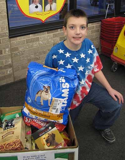 Joel Davis, 8, a student at Sunset Terrace Elementary School in Rochester, recently asked Stewartville residents to donate dog and cat food for the victims of Hurricane Sandy. Joel, who collected the donations at Fareway on Saturday, Dec. 1, also set up donation containers at a number of Rochester sites. Joel is the grandson of Pauline Fontaine of Stewartville. 