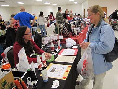 Kathy Dux of rural Stewartville, right, talks with Rachel Perkins, an independent consultant for Arbonne International, at the Holiday Extravaganza at the Stewartville Civic Center on Sunday, Dec. 2. Hundreds of local and area shoppers browsed among the items offered at about 40 businesses.     