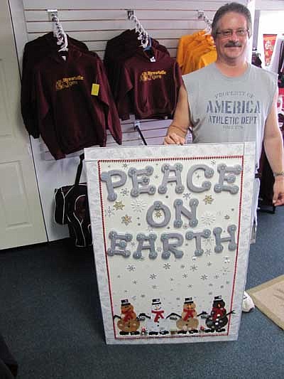 At left is Curt Mrotek, who joined his wife, Tamra, to make the winning life-sized Christmas card.  