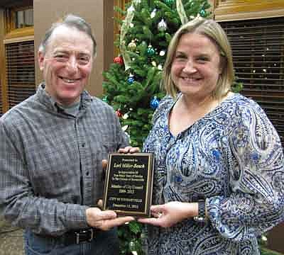 Lori Miller-Beach, who concluded her four-year term on the Stewartville City Council last week, accepts an appreciation plaque from Mayor Jimmie-John King after the City Council's last meeting of the year on Tuesday, Dec. 18. King thanked Miller-Beach for her hard work and willingness to serve on a variety of committees. Miller-Beach finished third among four candidates in the race for two open City Council seats last Novembe