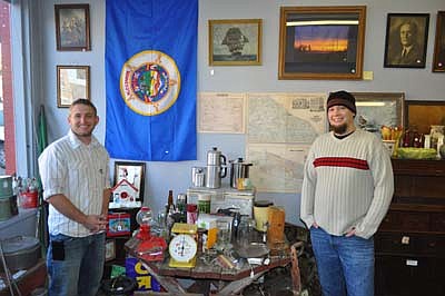Kyle Splittstoesser, left, and Andy Wohlhuter stand near a display in their Spring Valley business, "Vintage Point Artifacts." The business will celebrate its grand opening on Saturday, Jan. 12. 