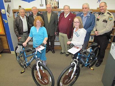Alashia McMurdo, a fourth grader, left; and Madelyn Timm, a fifth grader at Central Intermediate School, won bicycles last week in a drawing sponsored by the Stewartville Masonic Lodge and the Olmsted County Deputy Sheriff's Association. Students become eligible to enter their names in the drawing after they read a book. The more books they read, the more chances they have to win a bicycle. Masonic Lodge members include, from left, Len Griffith, treasurer; George Thompson, tyler(doorkeeper); Robert Lee, junior steward; Bill Hubbard, worshipful master; and George Menshik, chaplain. Zak Breitenbach, Stewartville's community oriented policing (COPS) deputy, is at far right. The Olmsted County Deputy Sheriff's Association donated $500 for Alashia's and Madelyn's bicycles, Breitenbach said.    