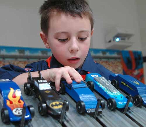 READY TO RUN -- Draven Bouillon places his car on the track at the annual Cub Scouts Pinewood Derby at Grace Evangelical Free Church on Saturday, Jan. 19.