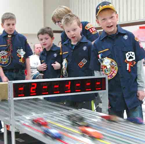 A RACE TO THE FINISH! -- Cub Scout Pack 156 held its annual Pinewood Derby at Grace Evangelical Free Church on Saturday, Jan. 19. Scouts watching their cars cross the finish line include, starting from second from left, Ethan Stone, Charlie Wood, William Mueller (partially hidden), Tyler Giordano and Tanner Chvosta. 