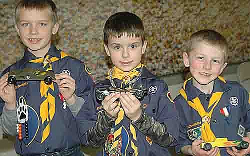 PINEWOOD CHAMPIONS -- Cub Scout Pack 156 held its annual Pinewood Derby at Grace Evangelical Free Church on Saturday, Jan. 19. The top three overall winners were Zach Boelman, center, first place; Thomas Root, left, second place; and Alexander Colligan, right, third place. 