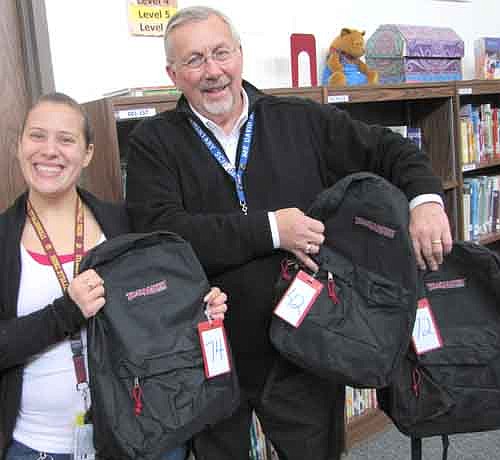 Courtney Fakler, a social worker and elementary school counselor in Stewartville schools, and Dave Nystuen, principal of Bonner Elementary School, display the backpacks students are using for "The Backpack Program." 