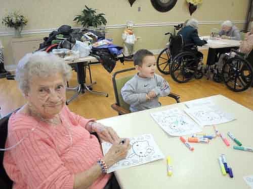 The Preschool I class from Endless Journey Child Care visited the Stewartville Care Center on Wednesday, Jan. 23.  The children and residents colored fun posters and shared a yummy treat together. Care Center resident, Lucile Lichte, enjoys coloring with Octavio Castellanos of Endless journey Child Care.