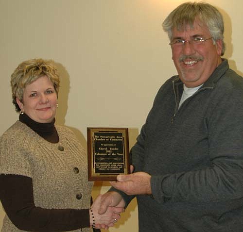 Cheryl Roeder accepts the Chamber's Volunteer of the Year Award for 2012 from Mark Podein, outgoing Chamber president.