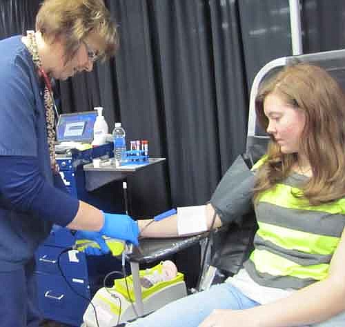 Mikayla Engel, a junior, right, is one of many Stewartville High School students who gave blood at the Mayo Clinic Blood Drive at SHS on Wednesday, Jan. 30. Deb Gerber, a phlebotomist with the Mayo Clinic, is at left. Mikayla explained why she gives blood. "I enjoy helping people, even if I don't know them,"&#8200;she said.