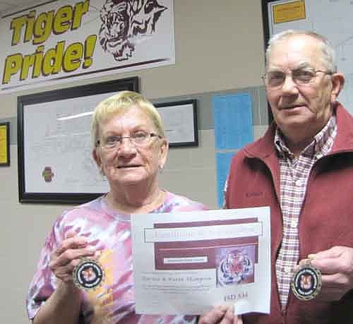 Harlan and Karen Thompson received Tiger Tokens last week for their work as volunteers for the Stewartville School District.